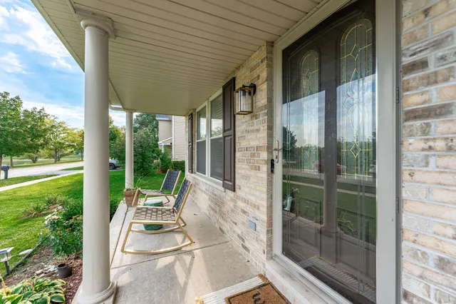 a front view of a house with wooden floor and windows