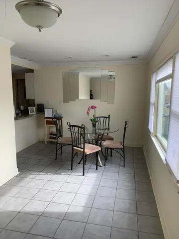 a view of a dining room with furniture and a rug