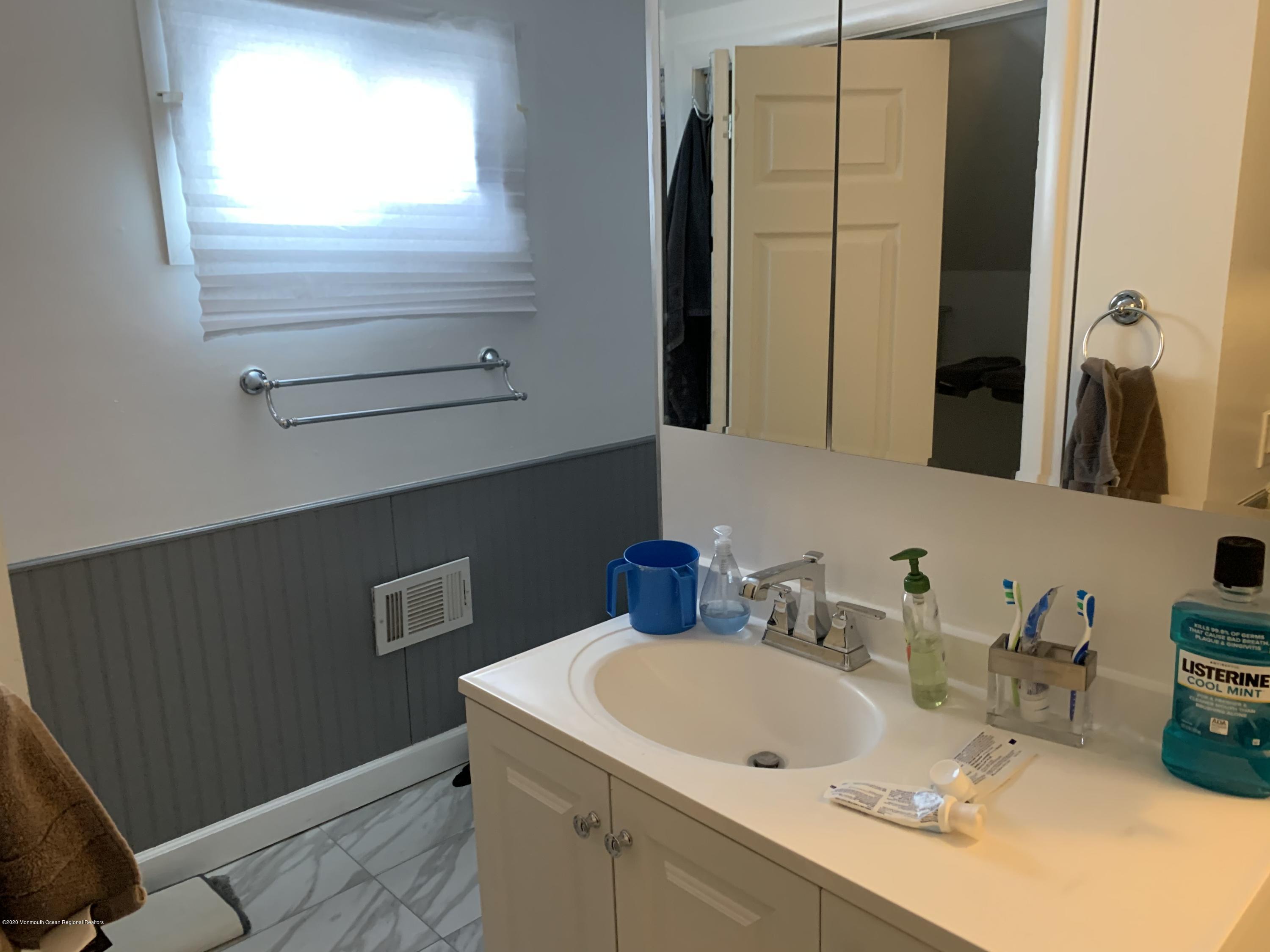 191 Norgrove Avenue Long Branch, NJ 07740 - Photo 6 of 6 a bathroom with a sink and a mirror