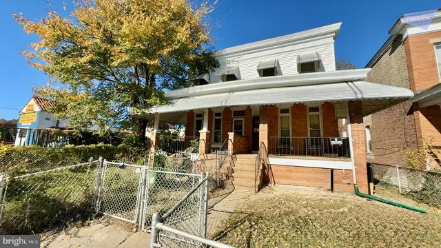 a front view of a building with a garden