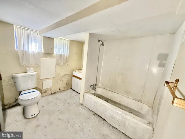 a bathroom with a toilet sink and a shower