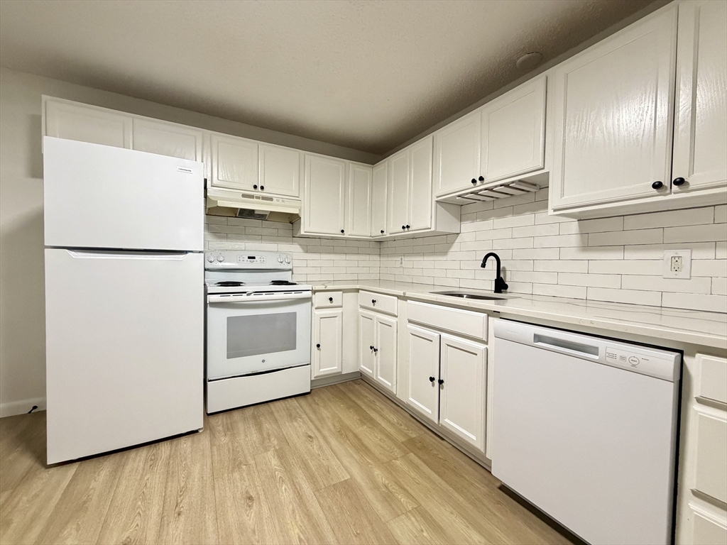 18 Pierce Street, Unit 3B Foxboro, MA 02035 - Photo 4 of 21 a kitchen with white cabinets white appliances and sink