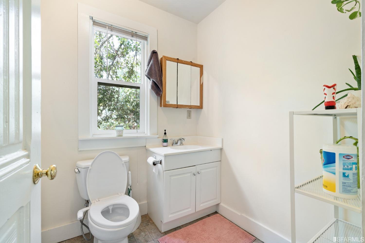 1934 Stuart Street Berkeley, CA 94703 - Photo 11 of 56 a bathroom with a toilet sink and mirror