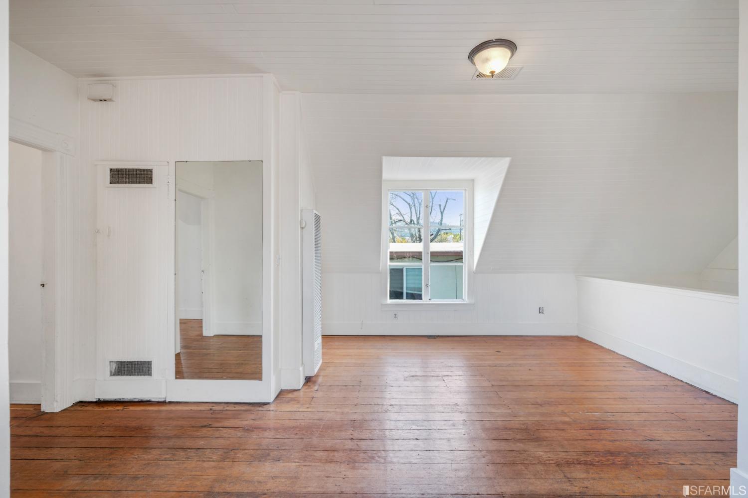 1934 Stuart Street Berkeley, CA 94703 - Photo 27 of 56 an empty room with wooden floor and windows