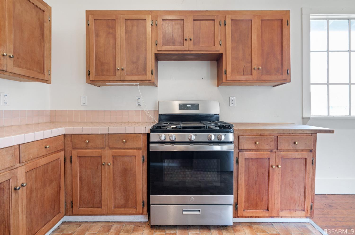 1934 Stuart Street Berkeley, CA 94703 - Photo 32 of 56 a kitchen with granite countertop white cabinets and stainless steel appliances