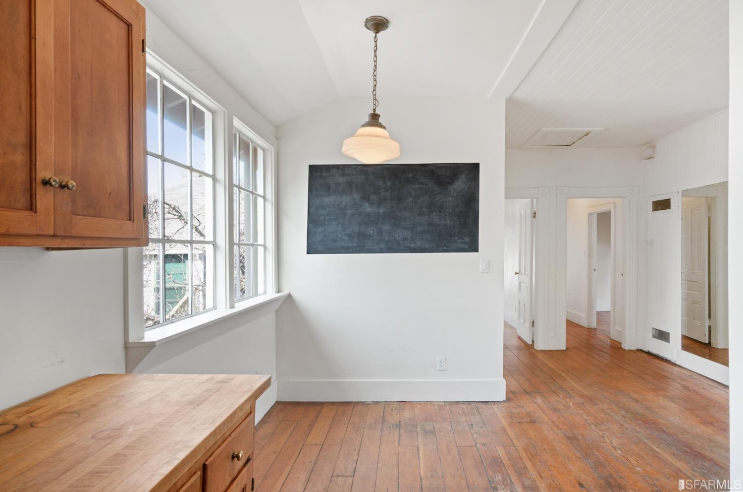 1934 Stuart Street Berkeley, CA 94703 - Photo 33 of 56 a workspace with wooden floor and windows