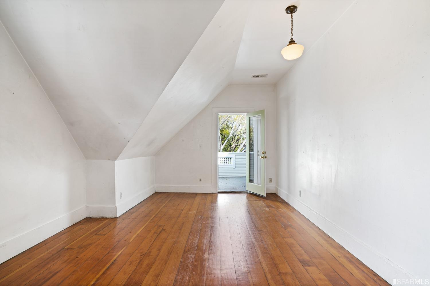 1934 Stuart Street Berkeley, CA 94703 - Photo 36 of 56 a view of an empty room with wooden floor and a window