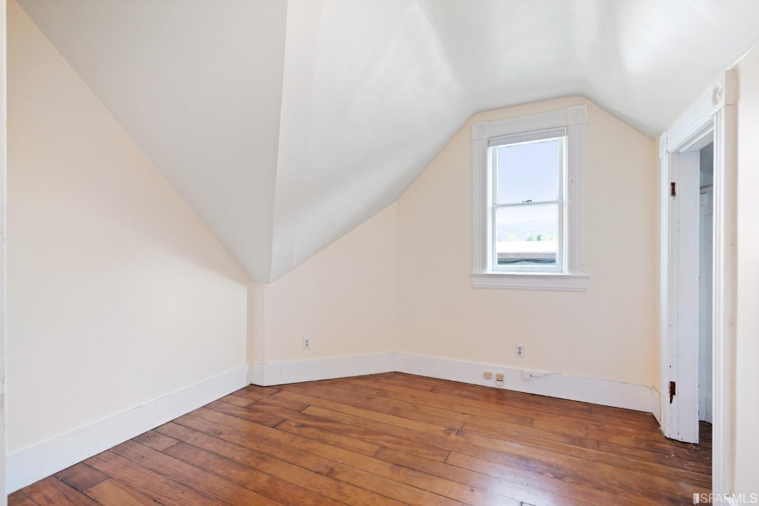 1934 Stuart Street Berkeley, CA 94703 - Photo 37 of 56 an empty room with wooden floor and windows