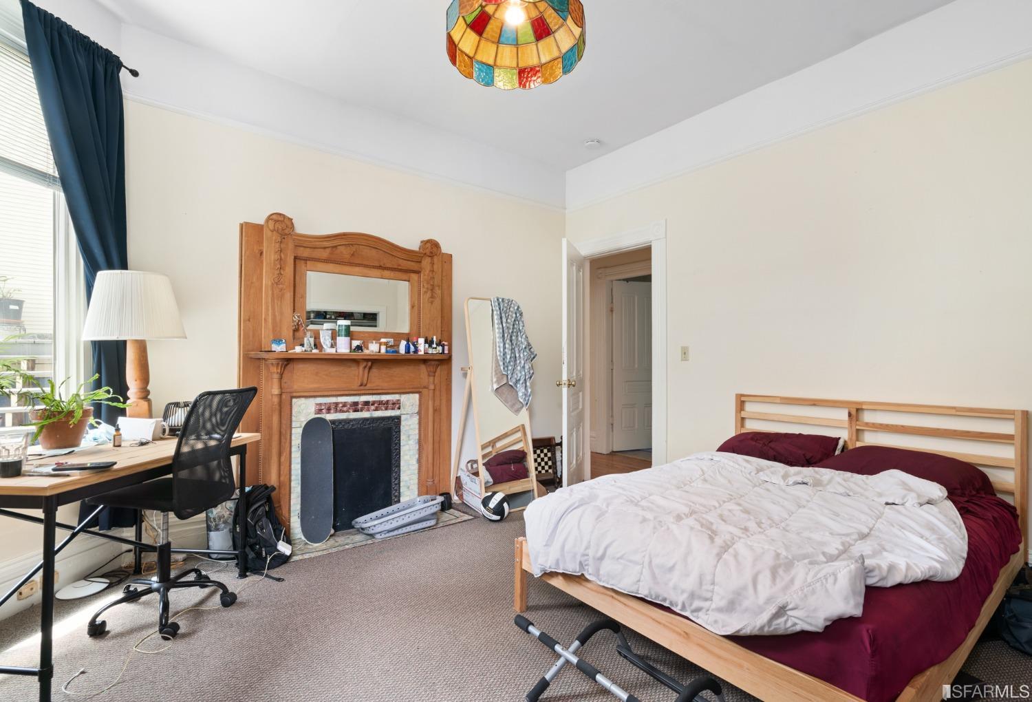 1934 Stuart Street Berkeley, CA 94703 - Photo 10 of 56 a bedroom with a bed and a fireplace