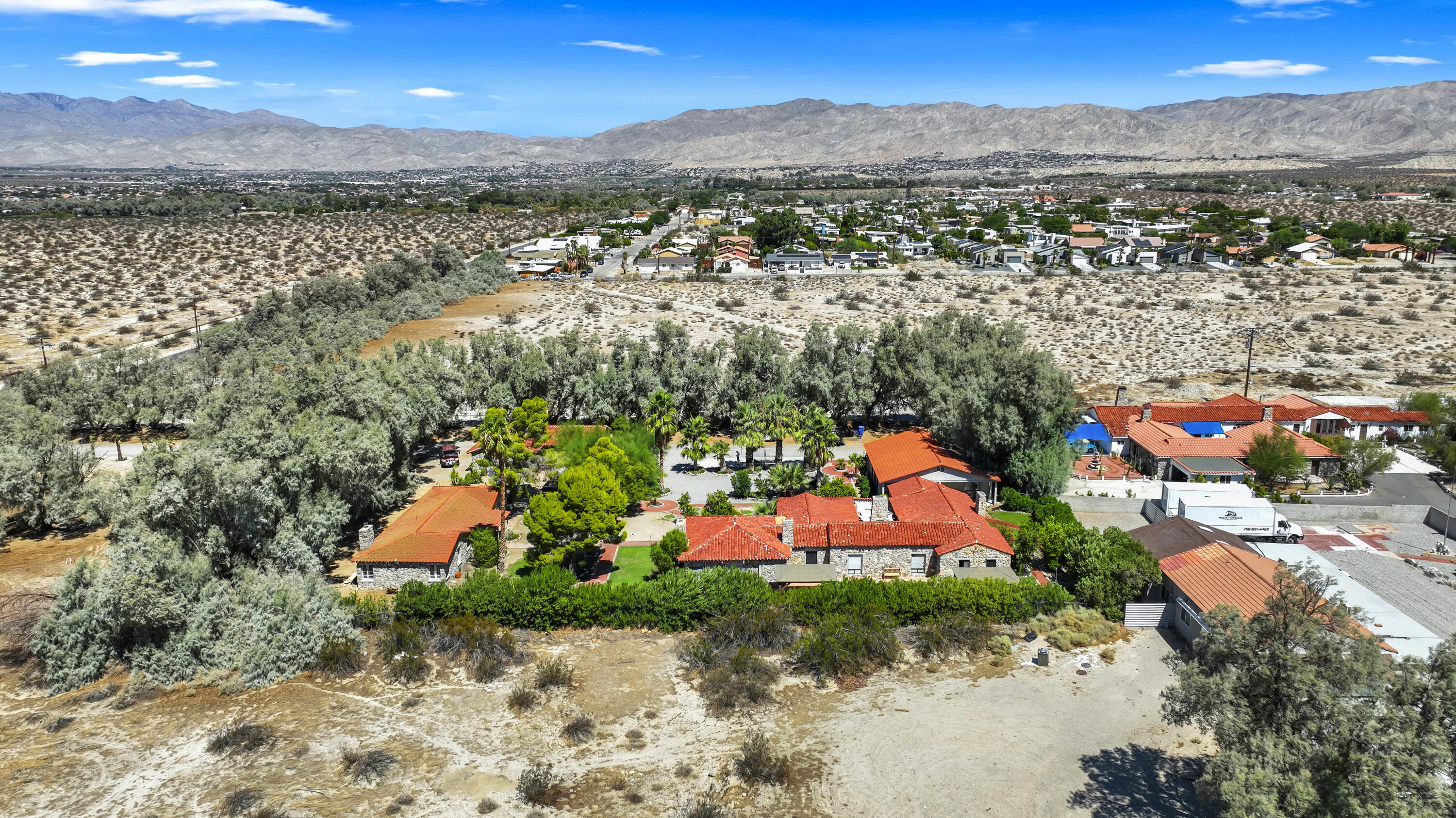 19120 Bubbling Wells Road Desert Hot Springs, CA 92241 - Photo 1 of 45 an aerial view of residential houses with outdoor space and trees