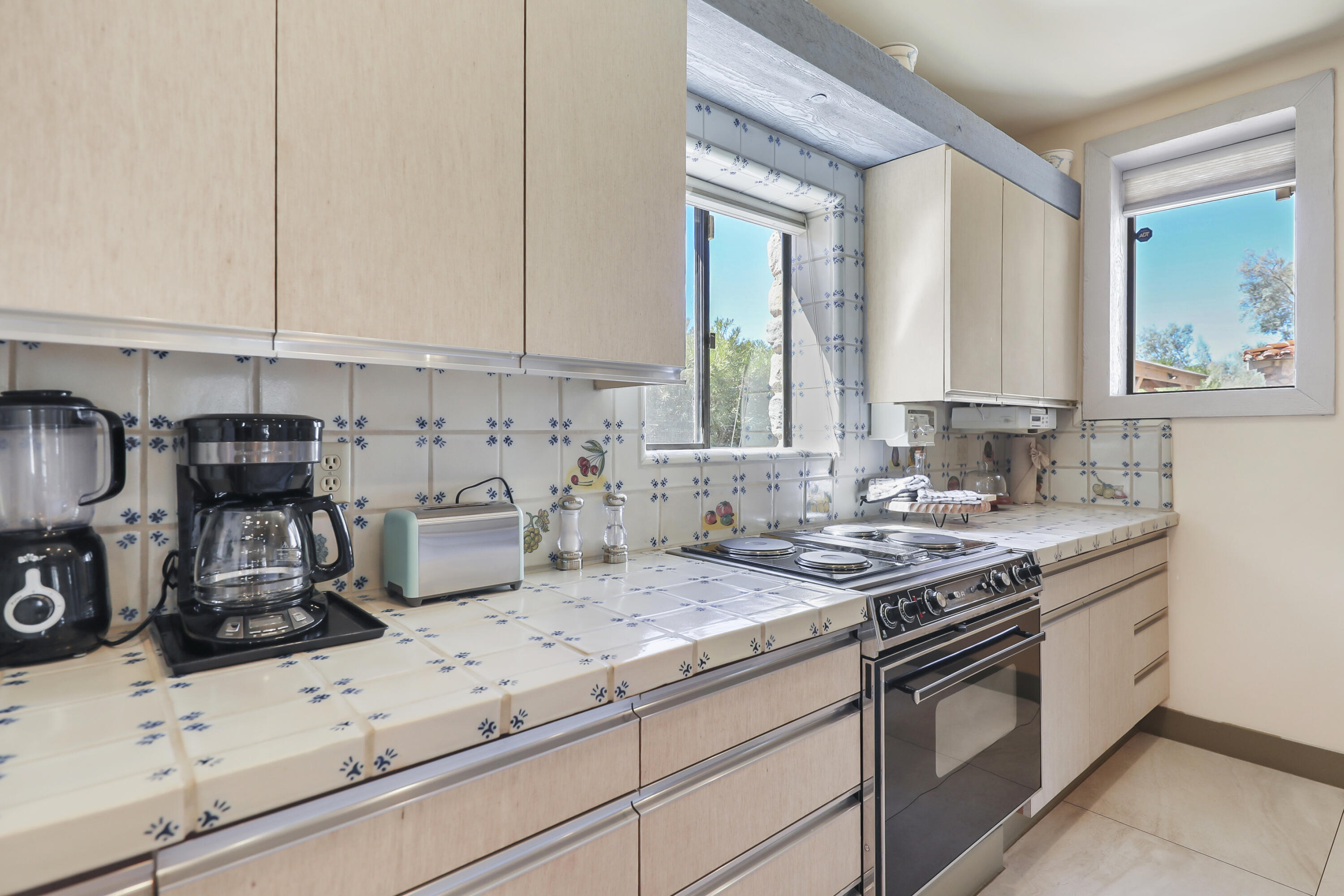 19120 Bubbling Wells Road Desert Hot Springs, CA 92241 - Photo 12 of 45 a kitchen with stainless steel appliances granite countertop a sink stove and cabinets