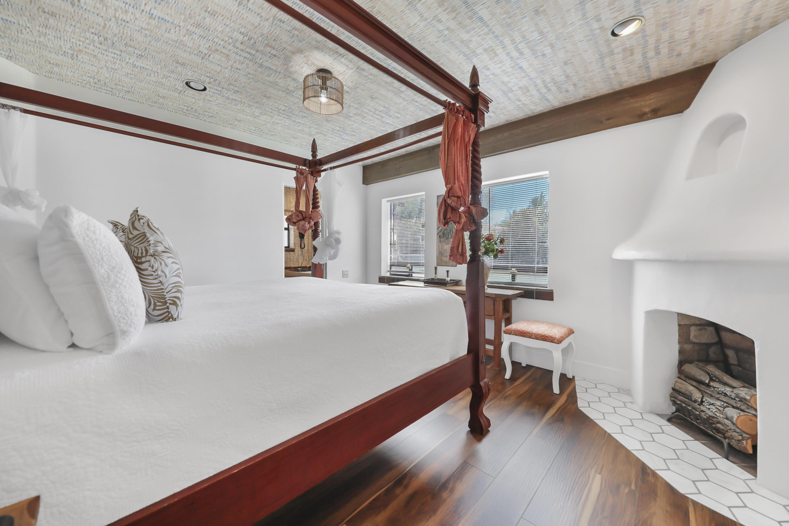 19120 Bubbling Wells Road Desert Hot Springs, CA 92241 - Photo 13 of 45 a bedroom with a bed a fireplace and a large window