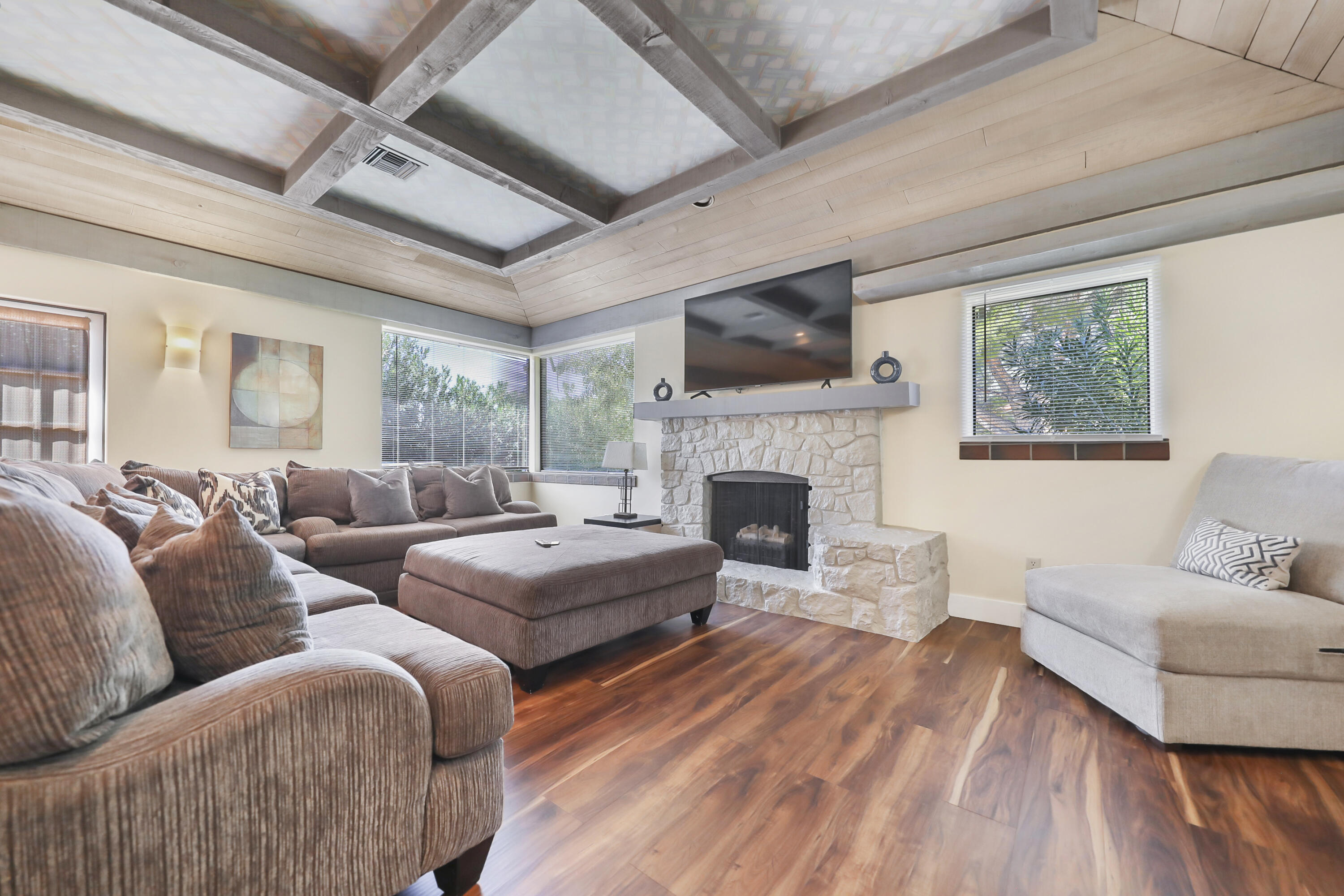 19120 Bubbling Wells Road Desert Hot Springs, CA 92241 - Photo 18 of 45 a living room with furniture large window and a fireplace
