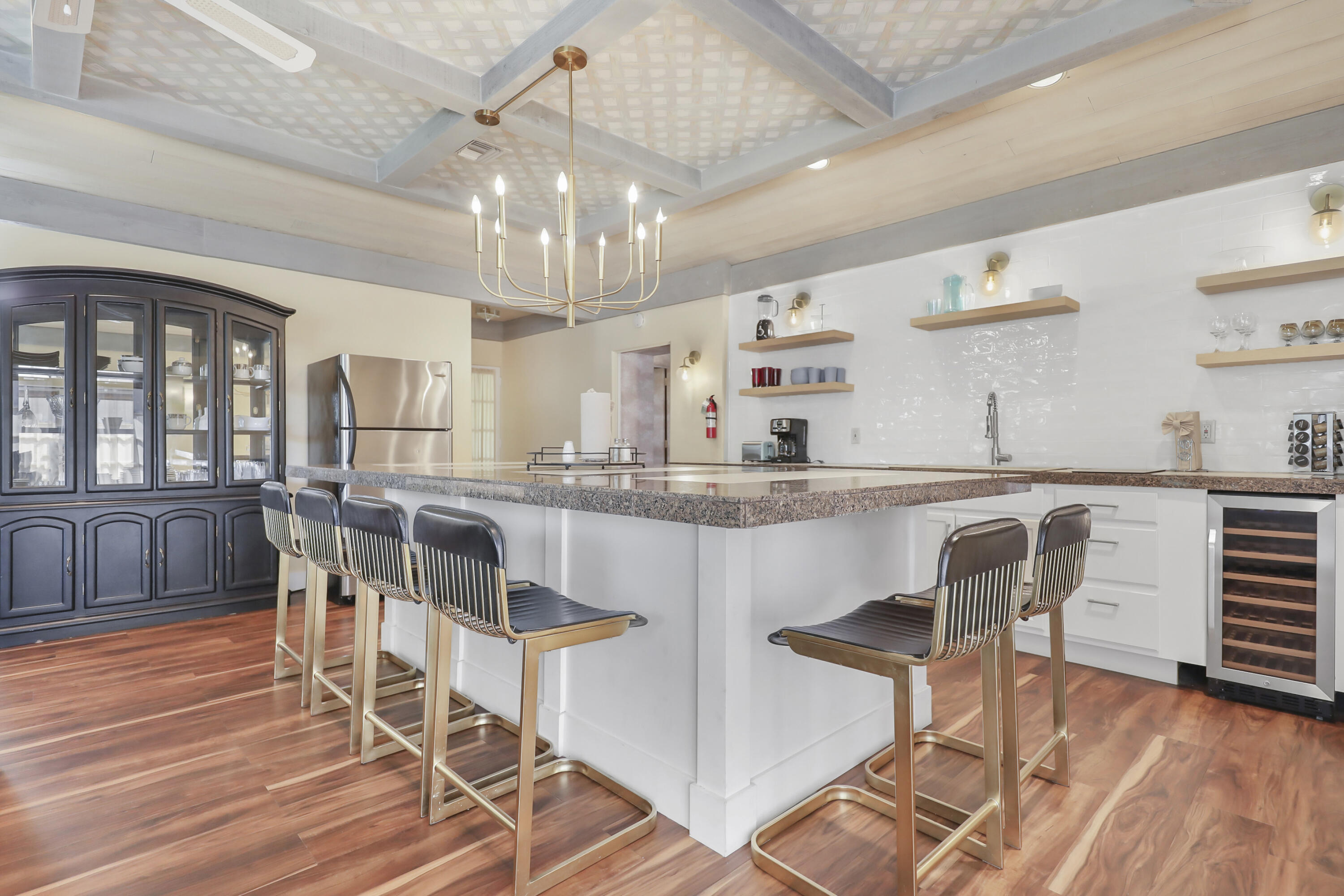 19120 Bubbling Wells Road Desert Hot Springs, CA 92241 - Photo 20 of 45 a kitchen with stainless steel appliances kitchen island granite countertop a table chairs cabinets and wooden floor