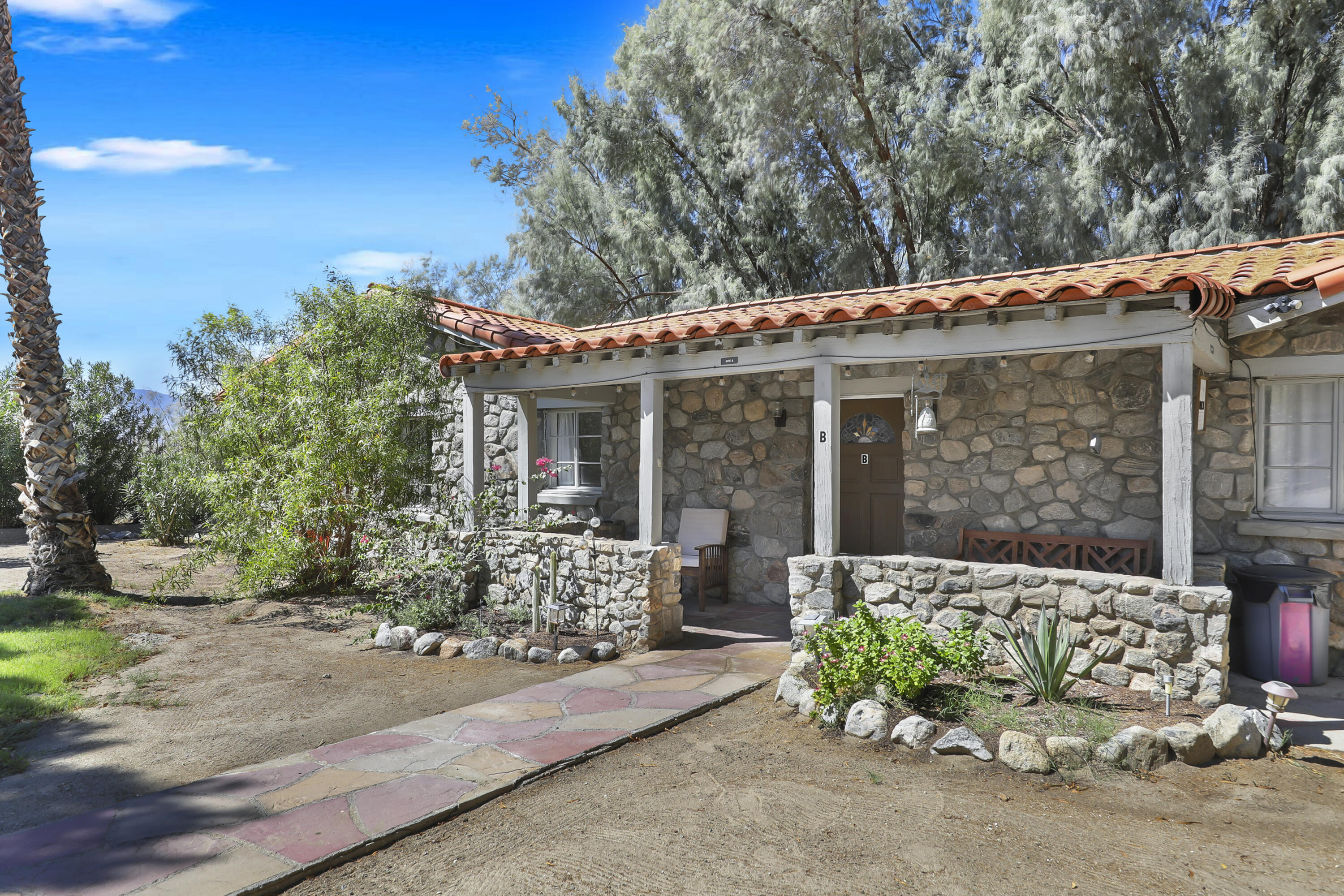 19120 Bubbling Wells Road Desert Hot Springs, CA 92241 - Photo 27 of 45 front view of a house with a yard
