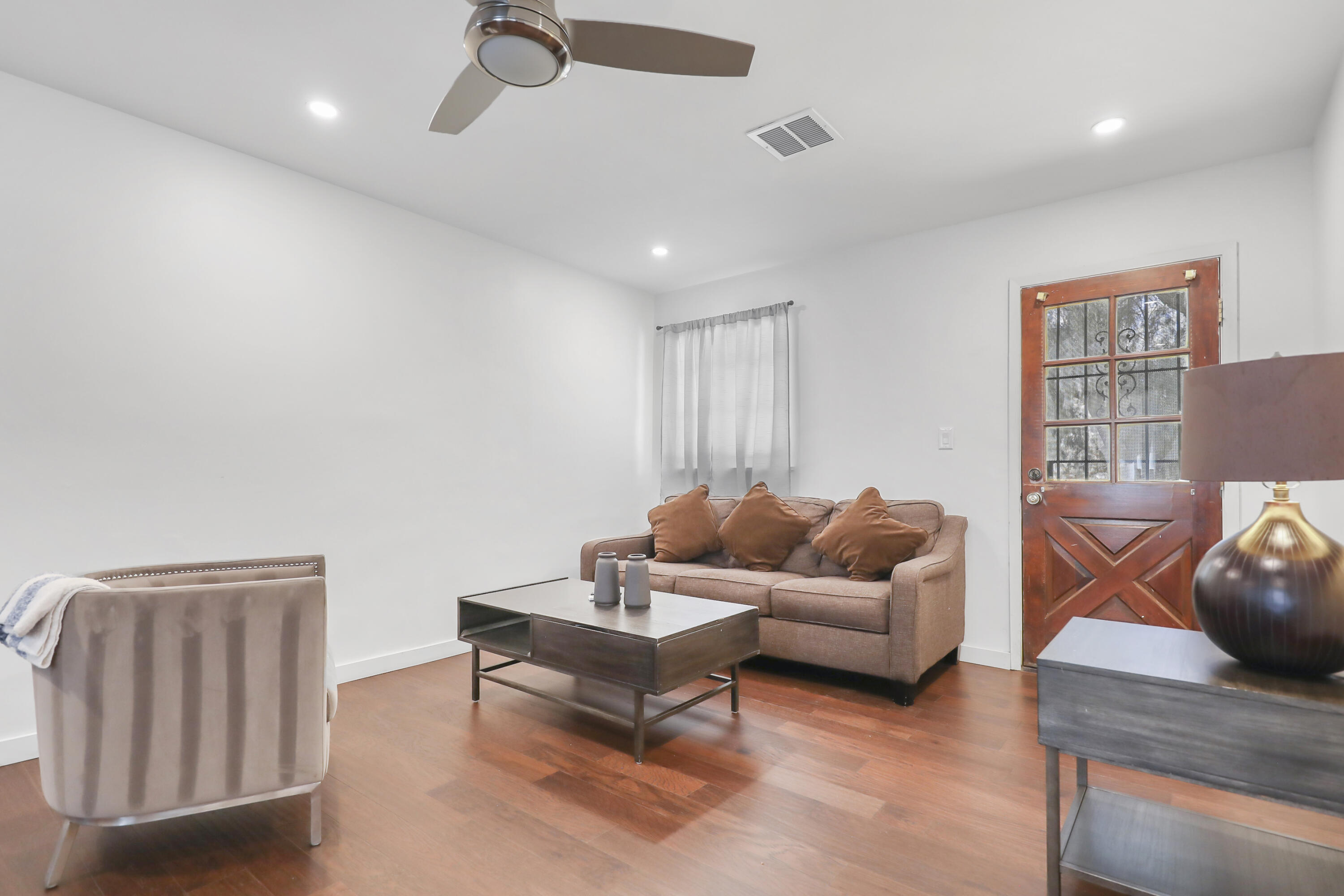 19120 Bubbling Wells Road Desert Hot Springs, CA 92241 - Photo 28 of 45 a living room with furniture and a wooden floor