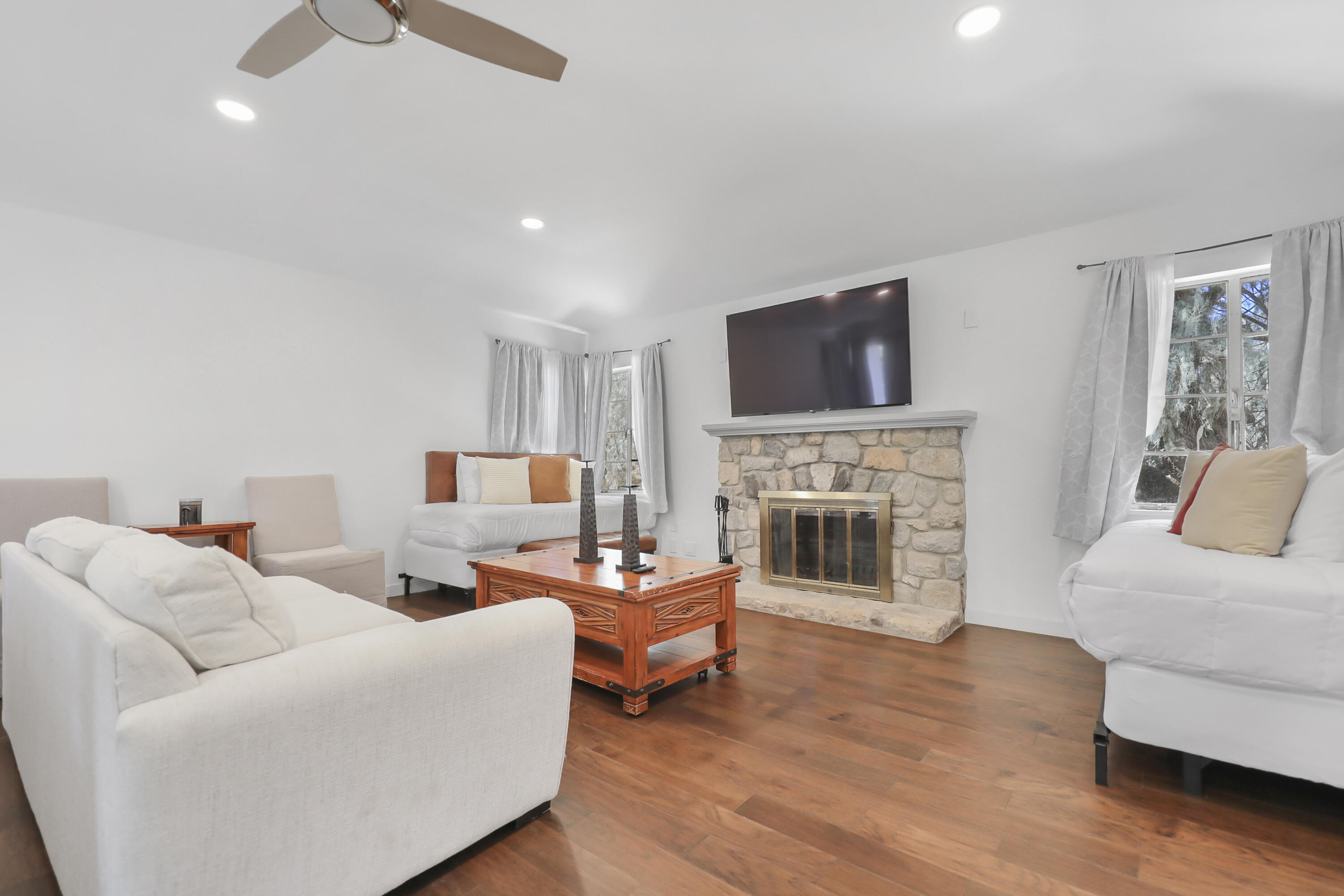 19120 Bubbling Wells Road Desert Hot Springs, CA 92241 - Photo 34 of 45 a living room with furniture a fireplace and a flat screen tv