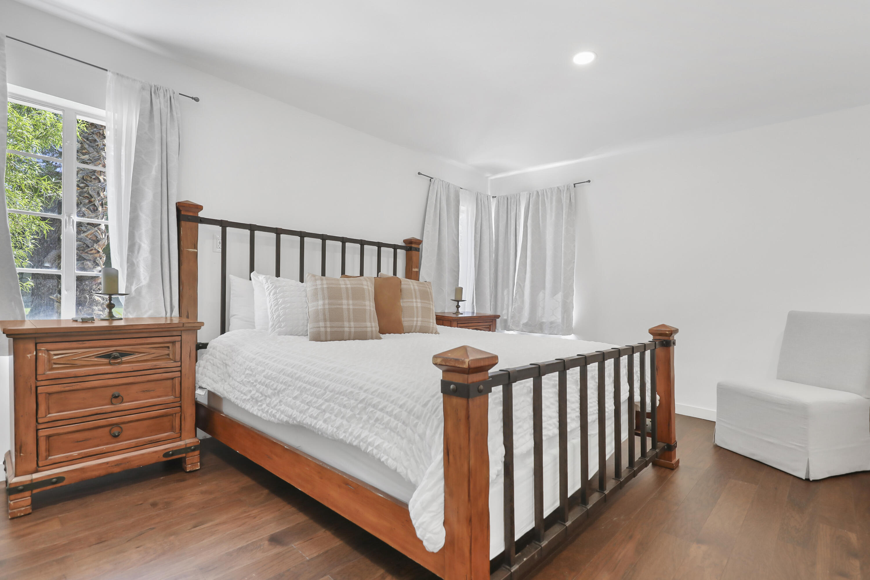 19120 Bubbling Wells Road Desert Hot Springs, CA 92241 - Photo 36 of 45 a bed sitting in a bedroom next to a window