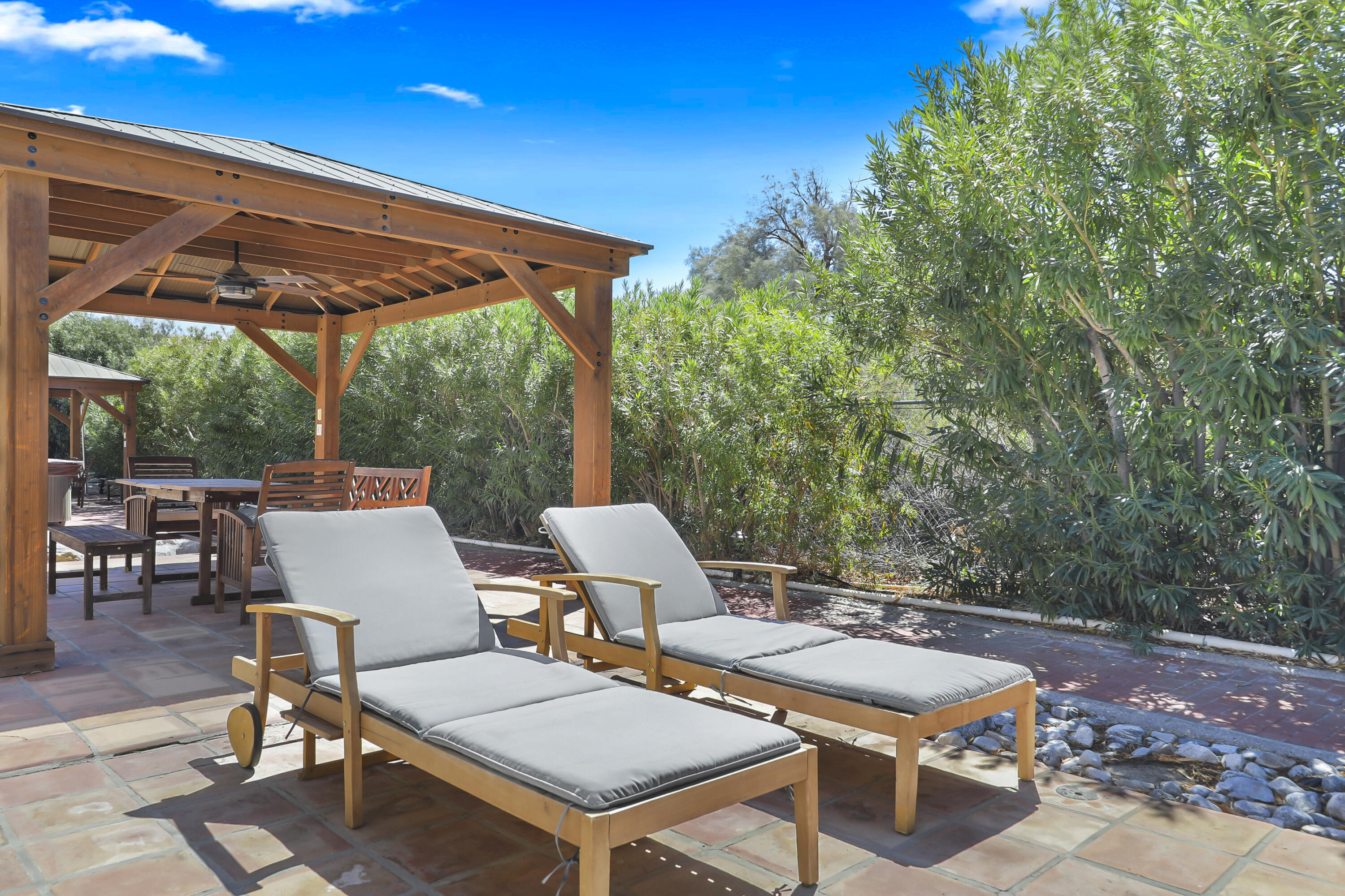 19120 Bubbling Wells Road Desert Hot Springs, CA 92241 - Photo 39 of 45 a backyard of a house with table and chairs