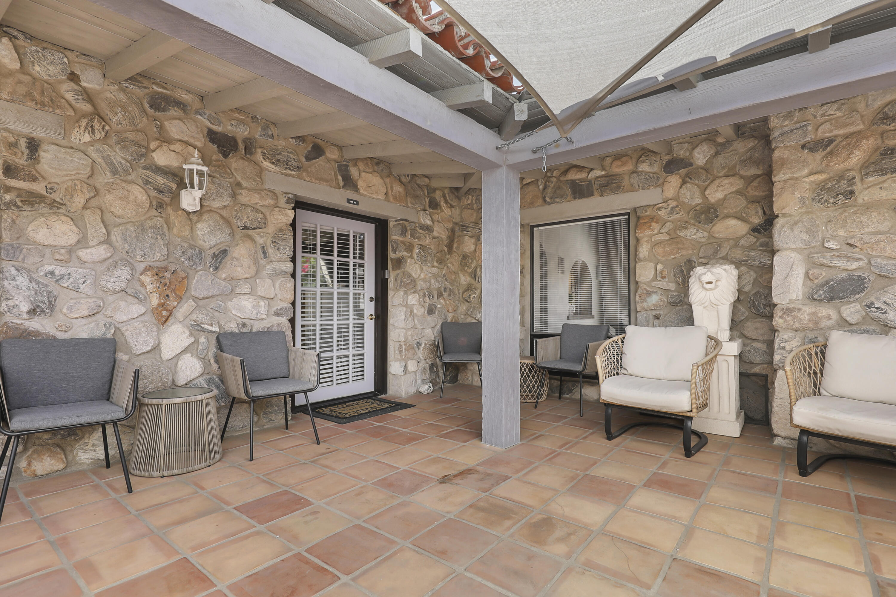 19120 Bubbling Wells Road Desert Hot Springs, CA 92241 - Photo 4 of 45 a balcony with couple of chairs and a rug