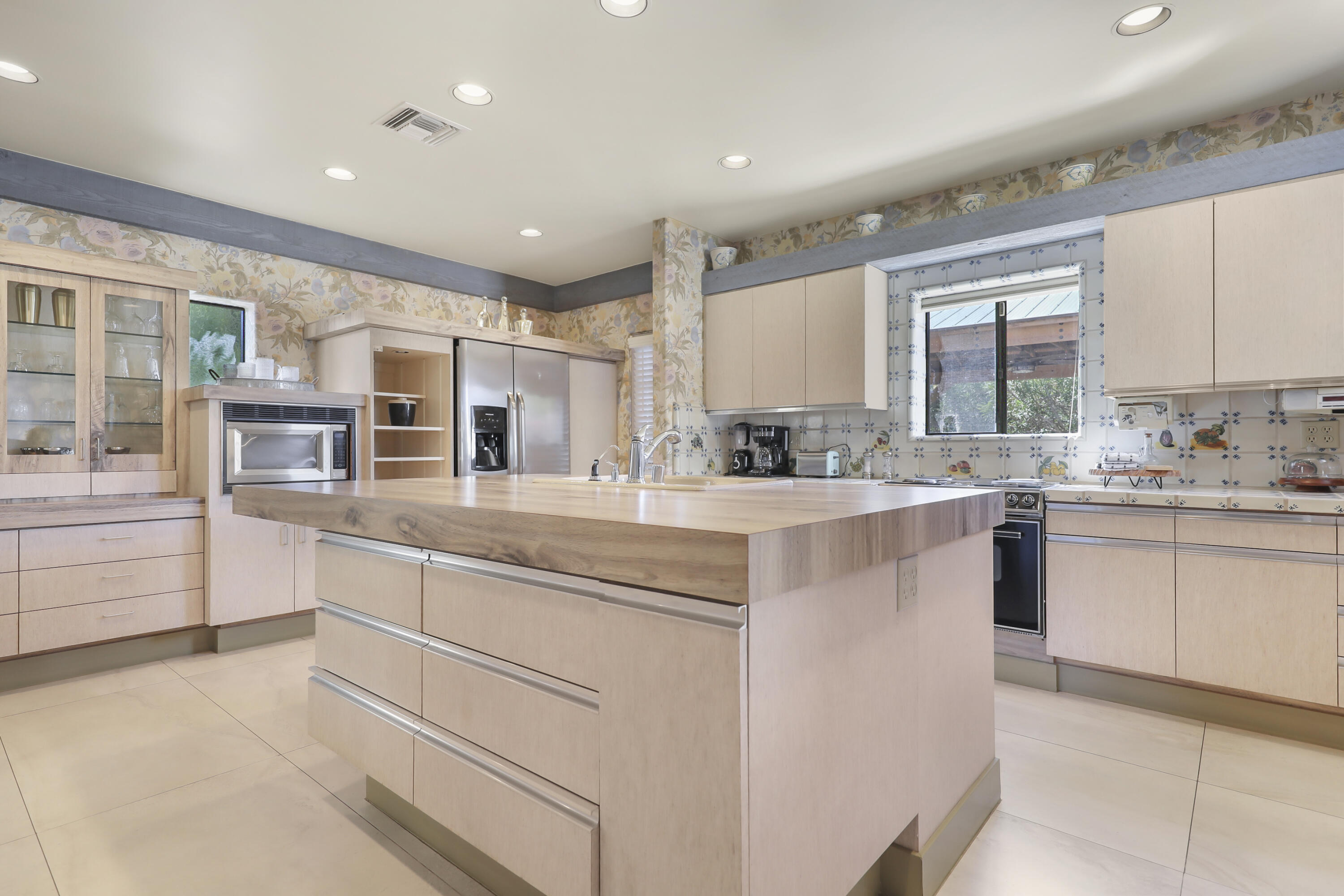 19120 Bubbling Wells Road Desert Hot Springs, CA 92241 - Photo 9 of 45 a kitchen with stainless steel appliances granite countertop a sink and cabinets