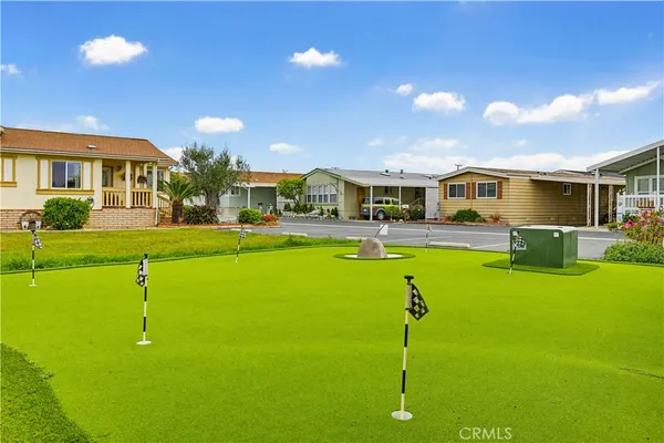 an outdoor patio with swimming pool and furniture