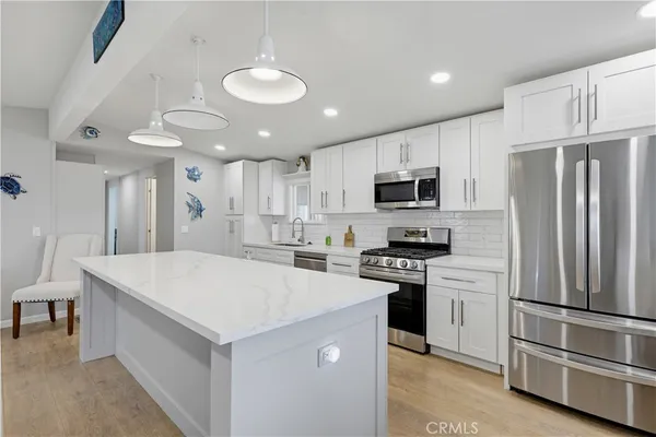 a kitchen with stainless steel appliances a stove sink microwave and cabinets