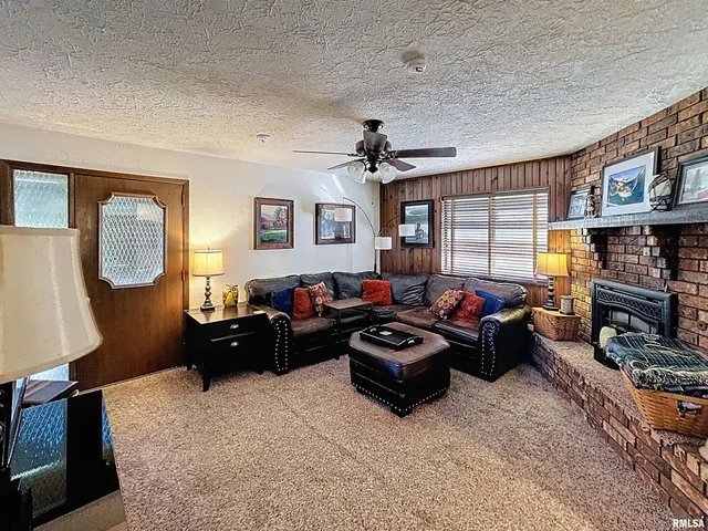 a view of a house with a yard and potted plants