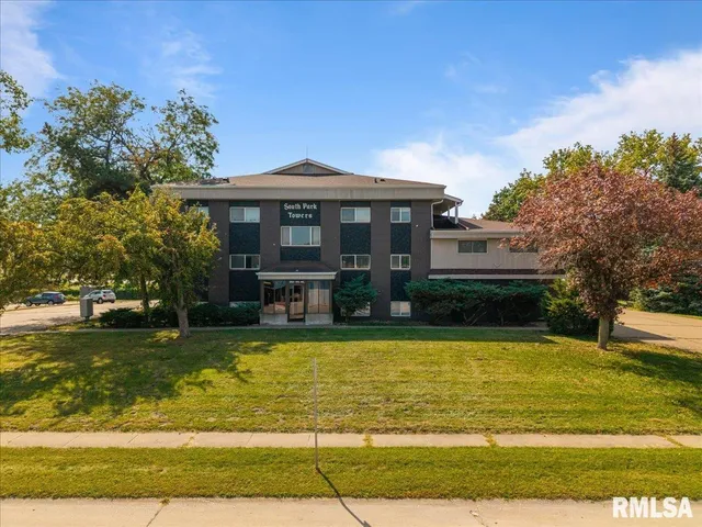 a white toilet sitting next to a bathroom sink and a mirror