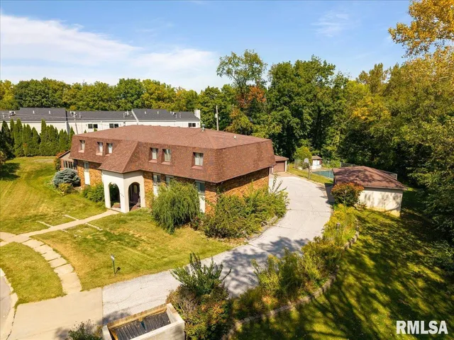 an aerial view of residential houses with outdoor space and river
