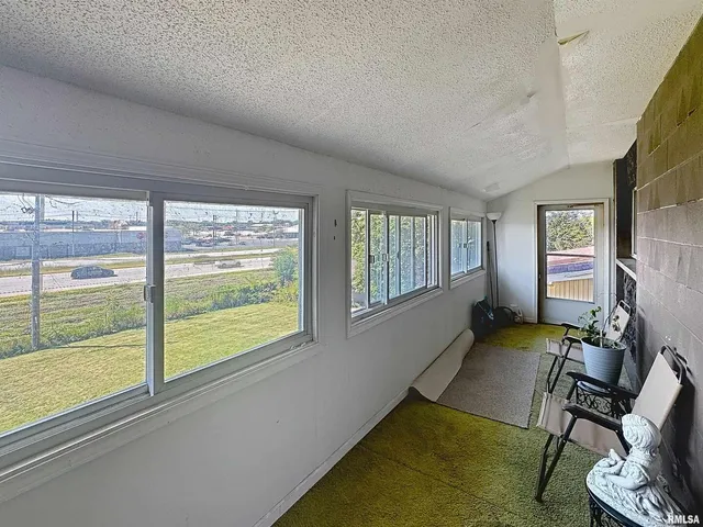 a kitchen with a refrigerator and white cabinets