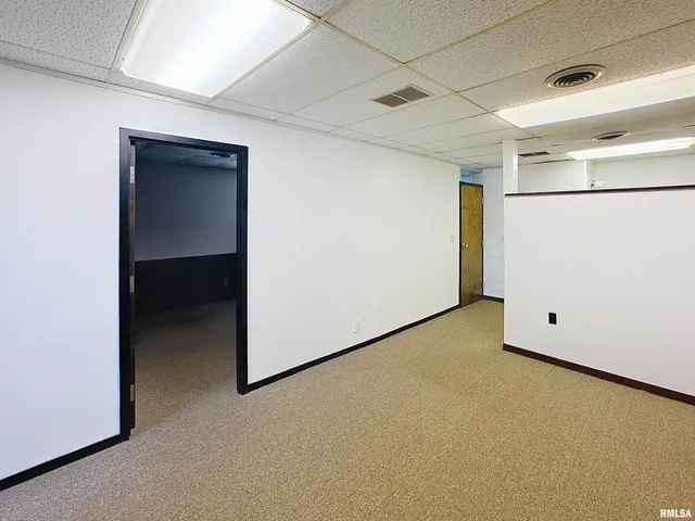 a kitchen with a refrigerator and a stove top oven