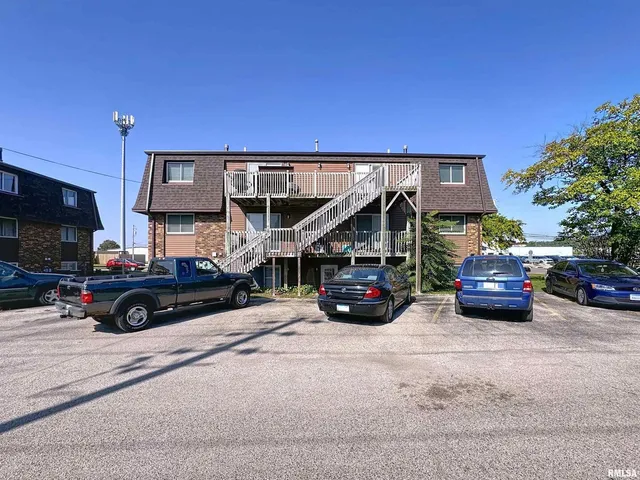 a living room with furniture a flat screen tv and gym equipment