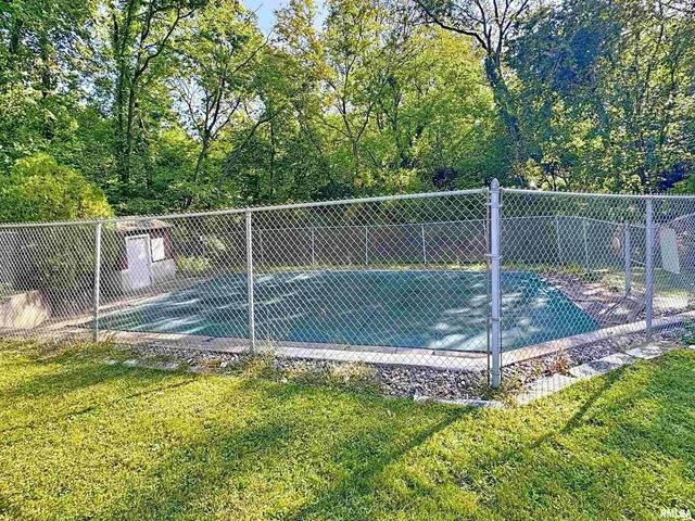 a living room with furniture and a dresser with wooden floor