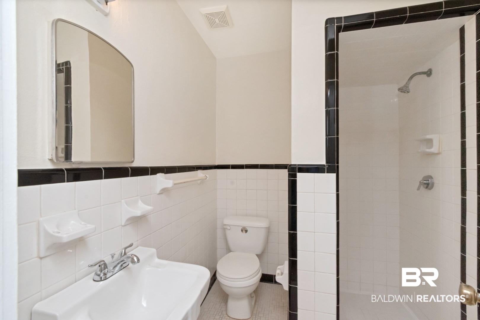 1477 Fairfield Street Mobile, AL 36606 - Photo 29 of 34 Full bath featuring tile walls, a stall shower, wainscoting, and tile patterned flooring