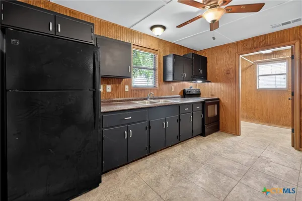 a spacious bathroom with a granite countertop sink a mirror and a shower