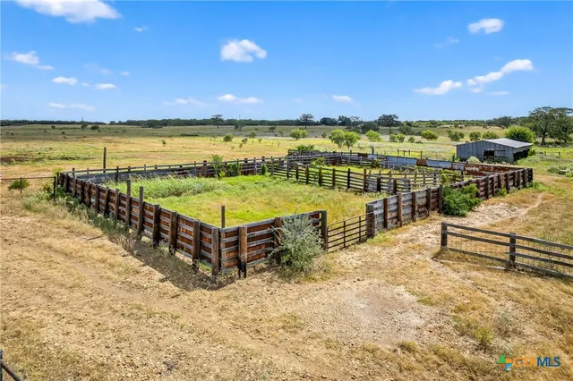 a view of a terrace with lawn chairs
