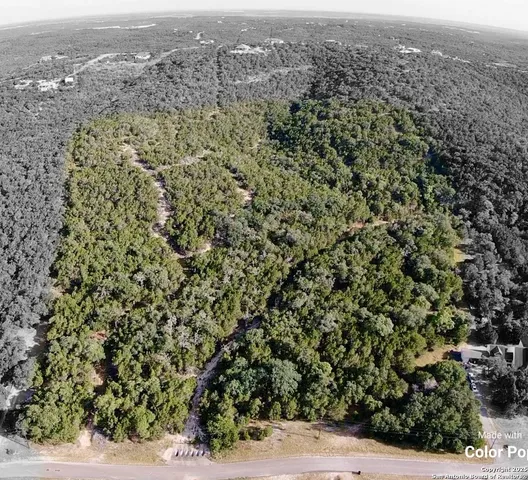 an aerial view of residential houses with city view