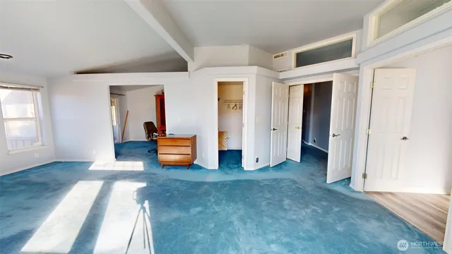 a view of an empty room and wooden floor