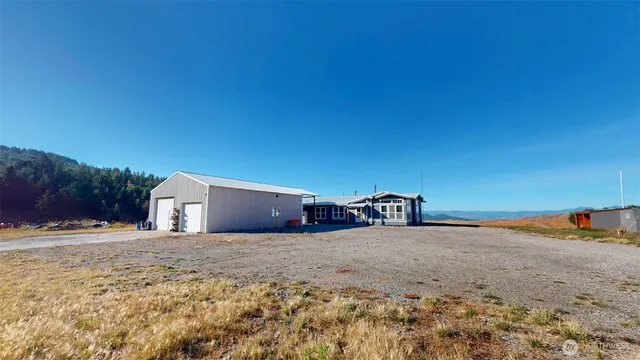 a view of a dirt road and yard