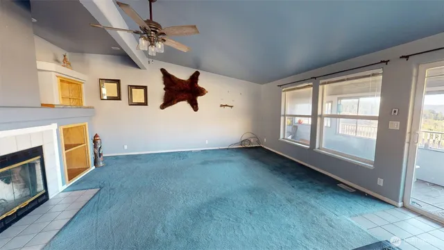 a view of a livingroom with wooden floor and a ceiling fan