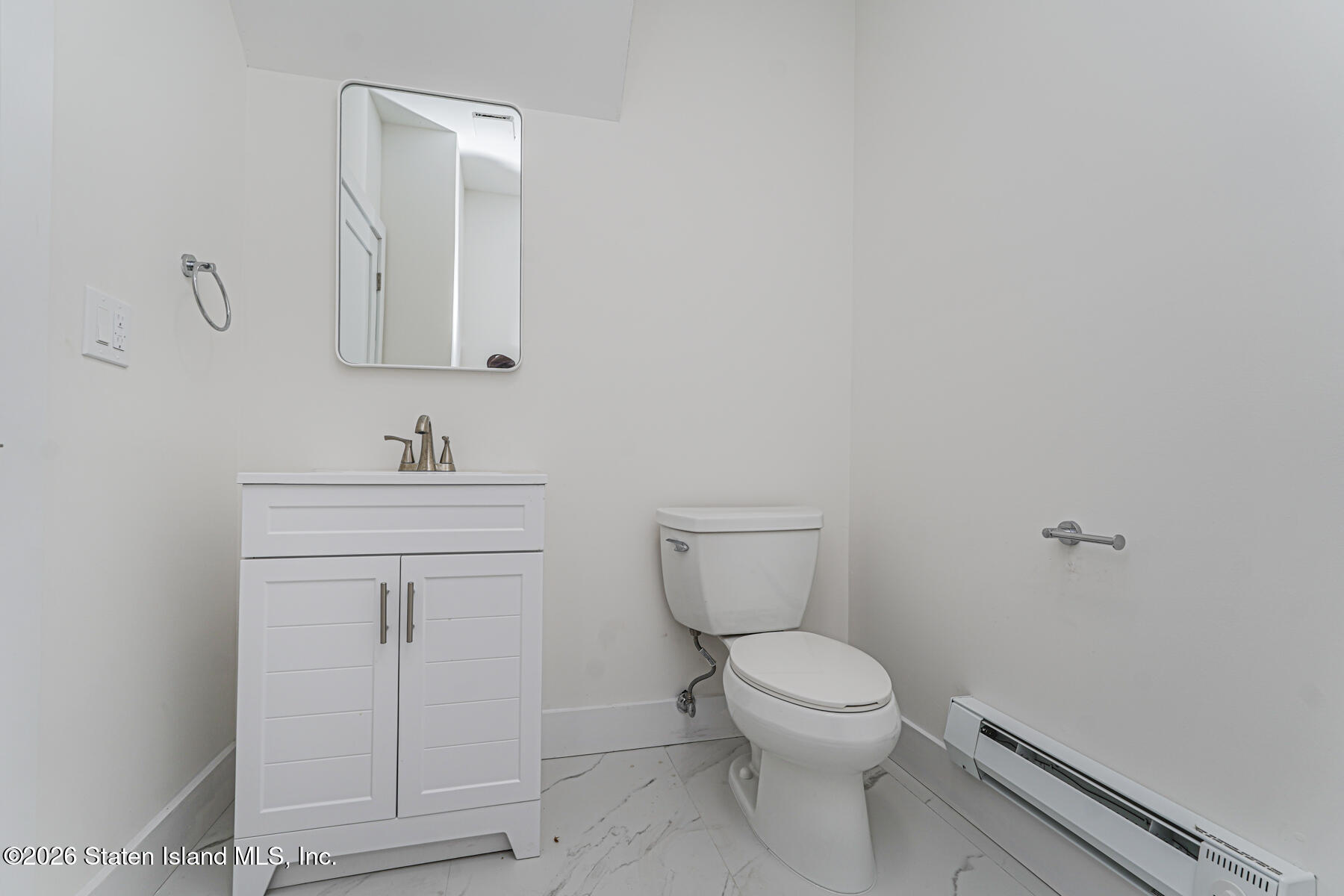 54 Cedarcliff Road Staten Island, NY 10301 - Photo 45 of 49 a bathroom with a toilet a sink and mirror