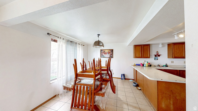 630 1100 West Provo, UT 84601 - Photo 44 of 64 Open-concept dining area featuring tiled flooring and a dedicated lighting fixture