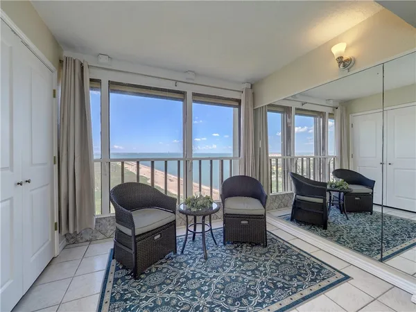 a living room with furniture rug and window