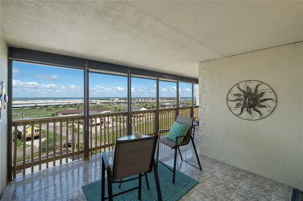 a view of a chairs and table in the balcony