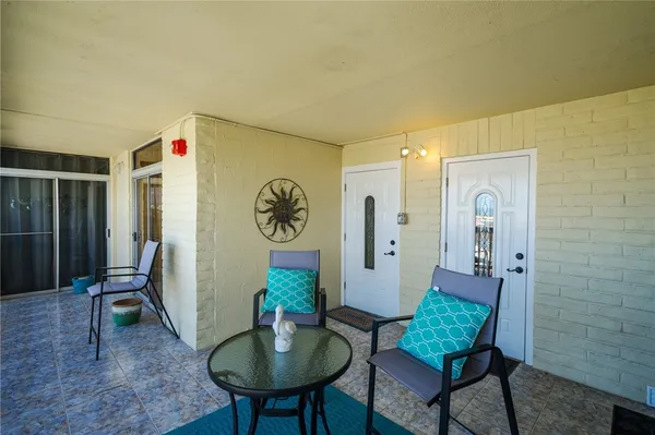a living room with furniture and a mirror