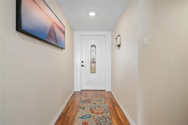 a view of hallway with wooden floor