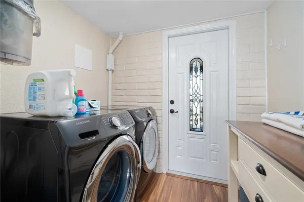 a utility room with sink dryer and washer