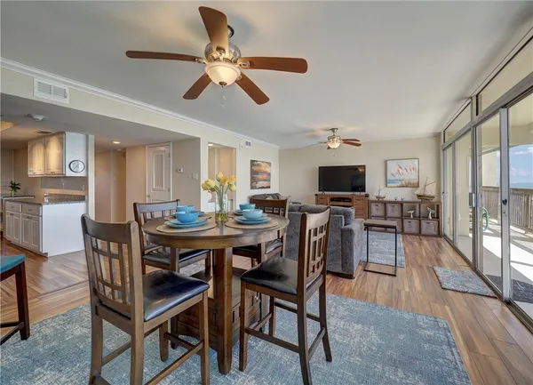 a view of a dining room with furniture and wooden floor
