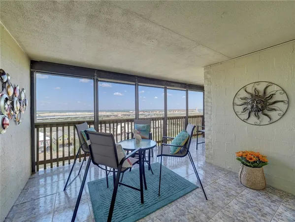 a dining room with furniture and front door